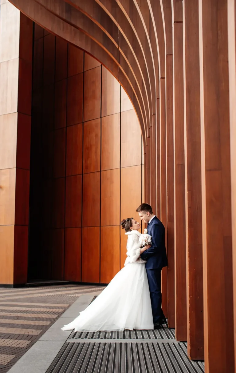 Couple marié devant une architecture en bois